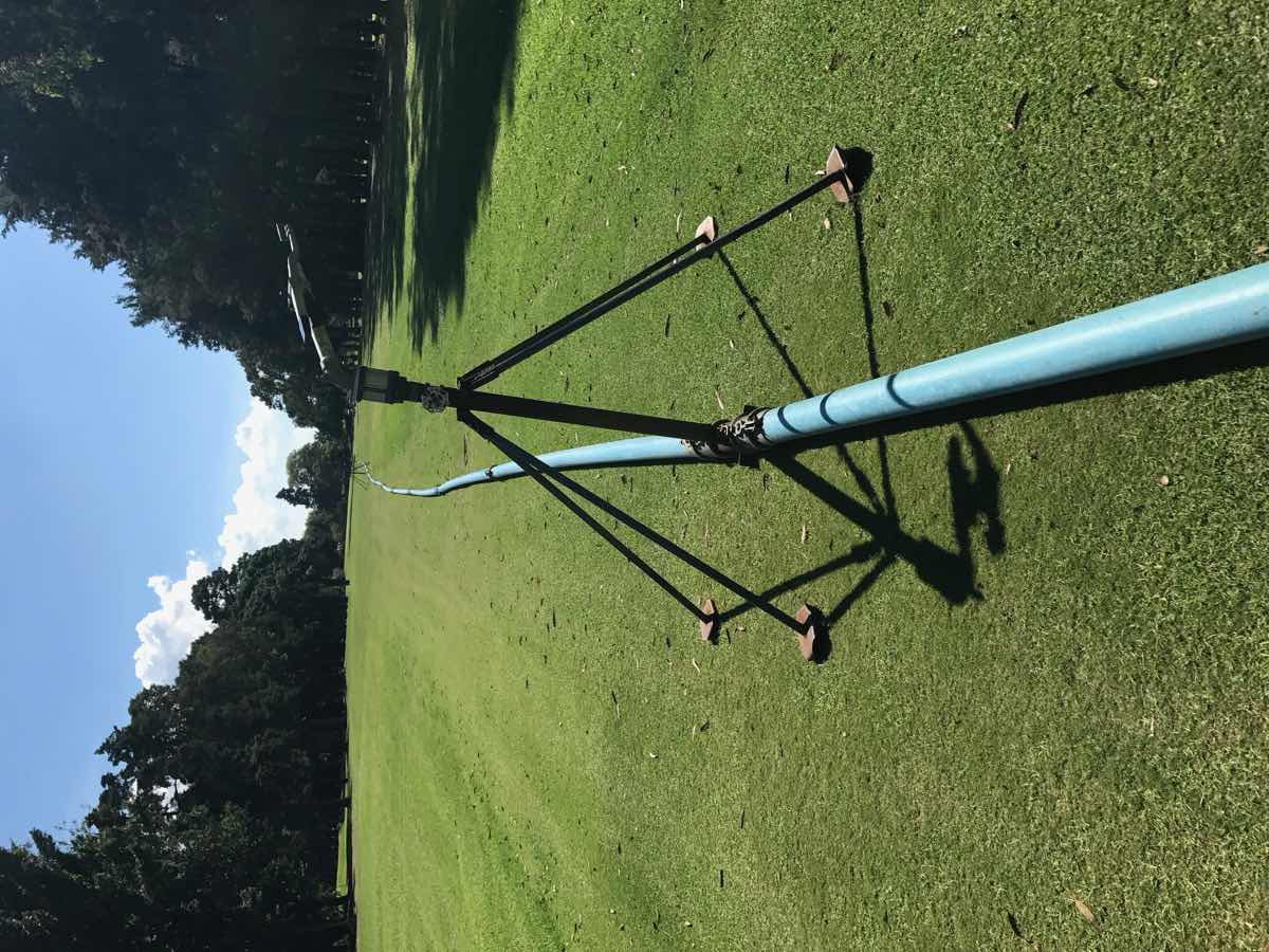 Grow-in sprinkler running on lay-flat pipe down a fairway